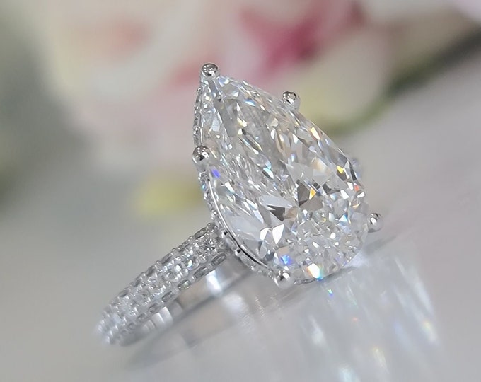 This classic diamond halo pave setting features a 4 carat IGI certified CVD lab grown teardrop diamond & 1.23 carats accent diamonds