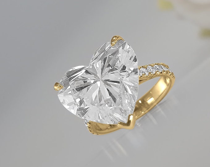 This Unique Rose Gold  Setting features a 9 Carat Heart Shaped IGI Certified CVD lab grown diamond accentuated with 0.64 carats side stones