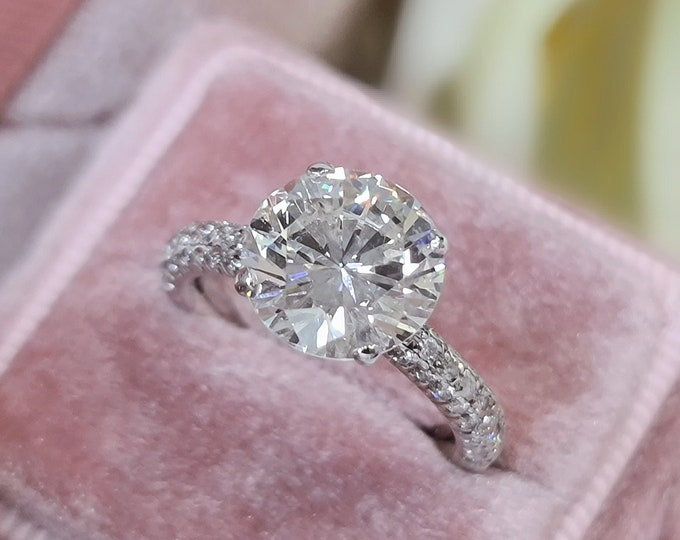 This classic 3 row diamond pave set solitaire ring features a 3 carat IGI certified Ideal round brilliant cut CVD lab grown diamond