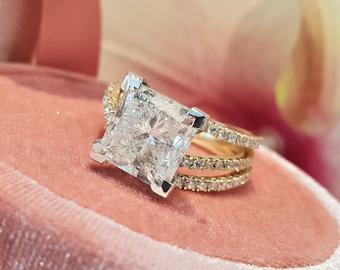 This unique two tone gold swirl diamond setting features a 3 carat IGI certified CVD lab grown princess cut diamond