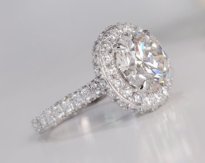 This unique double edge halo 14K gold diamond setting features a 3.50 carat IGI certified CVD lab grown ideal round brilliant cut diamond & 2.48 carats accent diamonds