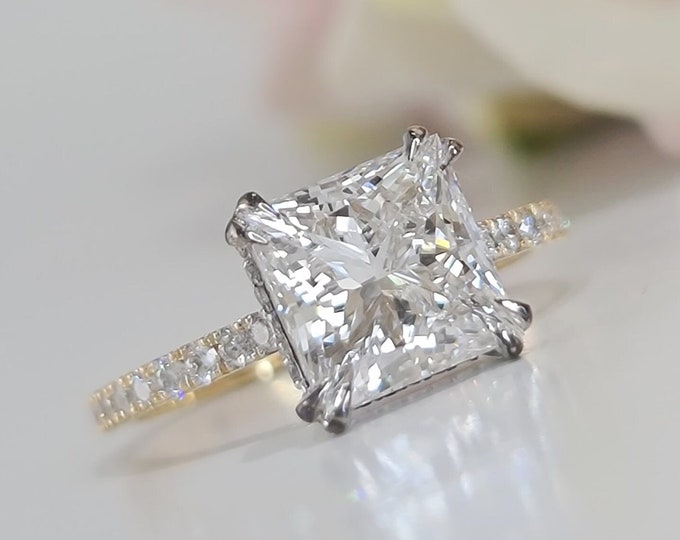 This hidden halo invisible gallery two tone gold setting features a 3 carat IGI certified CVD lab grown diamond and 0.45 carats accent diamonds