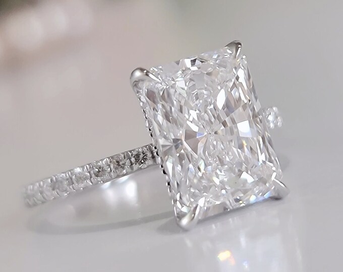 This Elegant white gold pave diamond setting features a 4 carat IGI Certified CVD lab grown elongated Radiant cut diamond