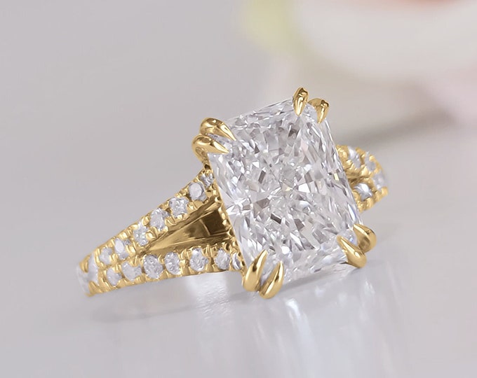 This elegant  14k gold split shank diamond setting features a 2 carat elongated radiant cut IGI certified CVD lab grown diamond
