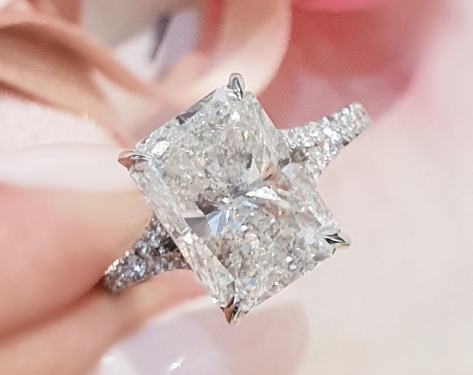 This elegant  14k gold split shank diamond setting features a 3 carat elongated radiant cut IGI certified CVD lab grown diamond