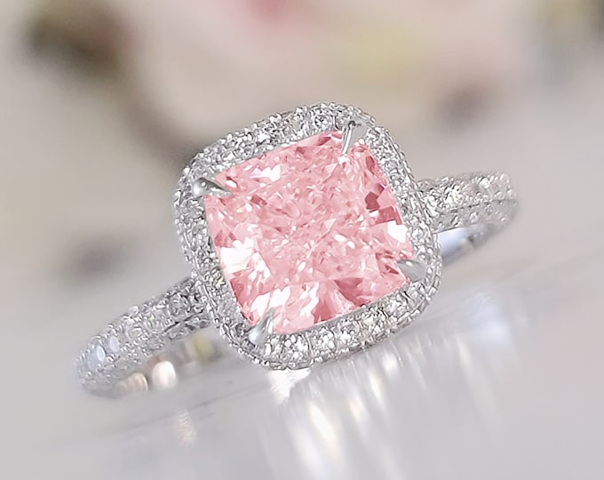 This unique double edge halo diamond setting features a 3 carat IGI certified CVD lab grown pink cushion cut diamond & 0.90 carats accent diamonds