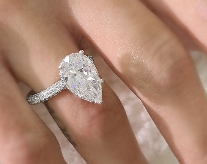 This classic diamond halo pave setting features a 5 carat IGI certified CVD lab grown teardrop diamond & 1.35 carats accent diamonds