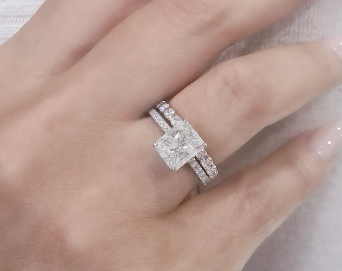 IGI certified 2 Carat Radiant Cut CVD lab grown diamond set in a classic low profile hidden halo diamond pave setting accompanied by a flushing 0.28 carats wedding band