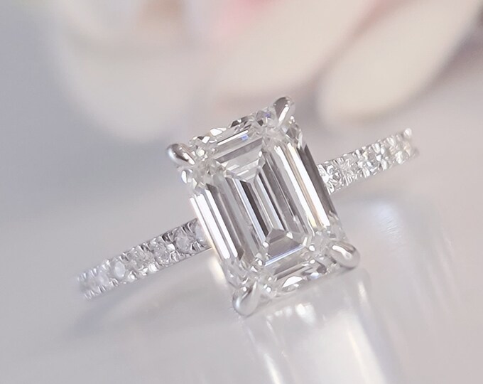 A timeless classic featuring a IGI certified 2.50 carat emerald cut CVD lab grown diamond and 0.46ct accent diamonds
