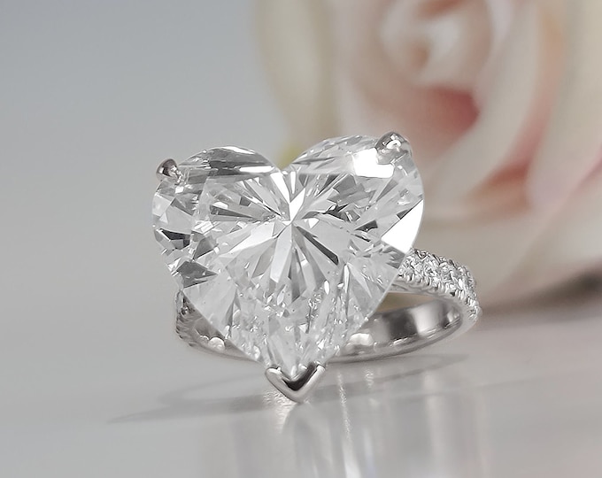 This Unique White Gold  Setting features a 9 Carat Heart Shaped IGI Certified CVD lab grown diamond accentuated with 0.64 carats side stones