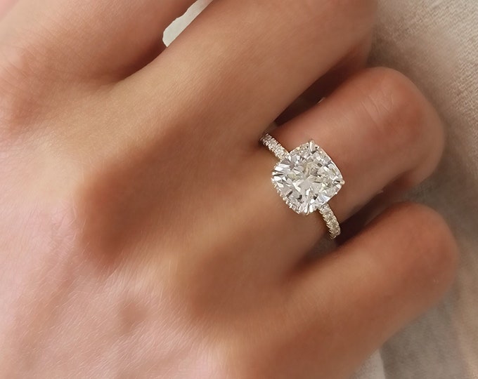 This classic 14K Yellow Gold hidden halo setting features a 3 carat IGI certified CVD lab grown cushion cut diamond & 0.47 carats accent diamonds