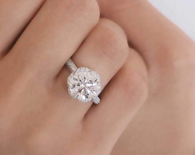 This flower inspired unique halo diamond setting features a 3 carat Ideal round brilliant cut IGI certified CVD lab grown diamond and is accentuated with 0.65 carats diamonds