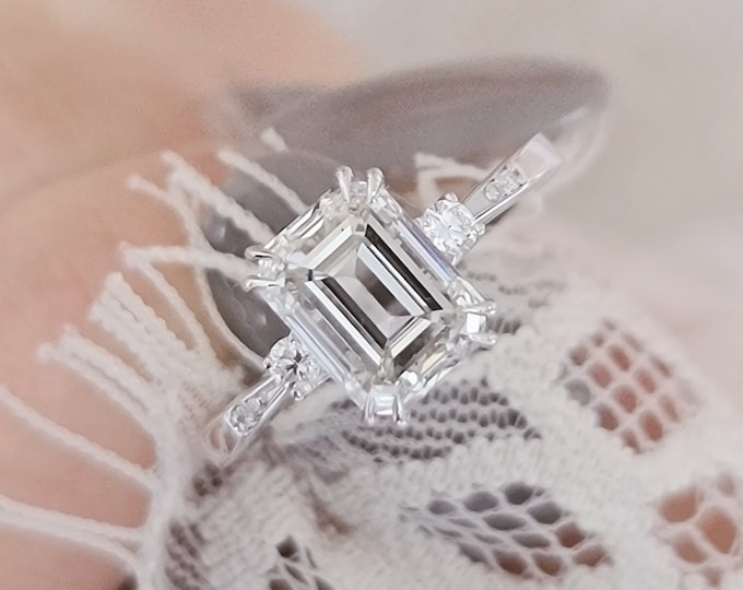 A timeless classic featuring a IGI certified 3 carat emerald cut CVD lab grown diamond and 0.13ct accent diamonds