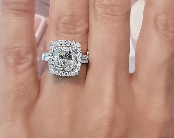 This sophisticated 14K gold setting features a 3 carat cushion cut IGI certified CVD lab grown diamond set in a 0.69 carat halo diamond setting accentuated with 0.56 carat tapered baguettes