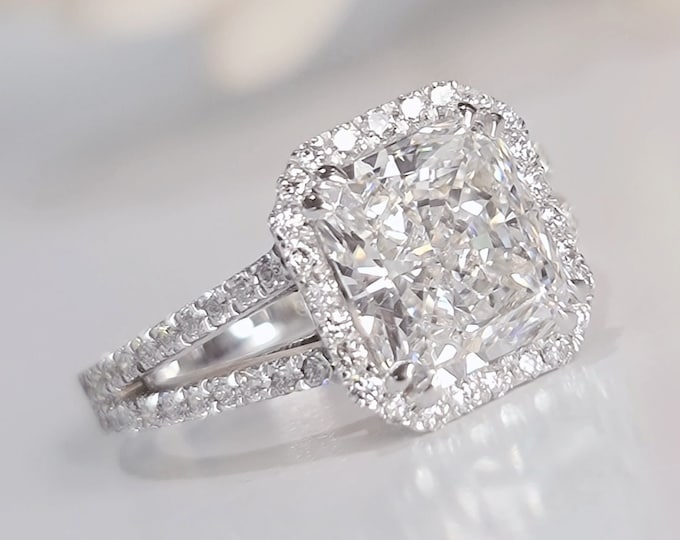 This stunning split shank diamond halo setting features a 3 carat radiant cut IGI certified CVD lab grown diamond set with 0.85 carat pave set diamonds
