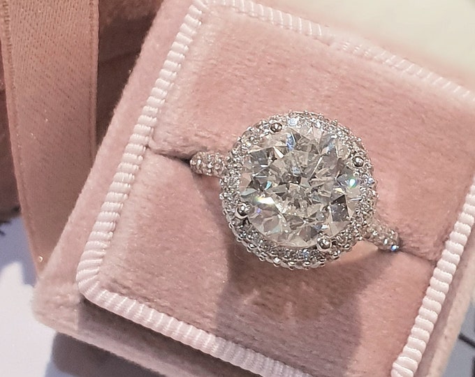 This solitaire high profile halo diamond cathedral setting features a 3 Carat IGI certified CVD lab grown diamond and 1.20ct accent diamonds