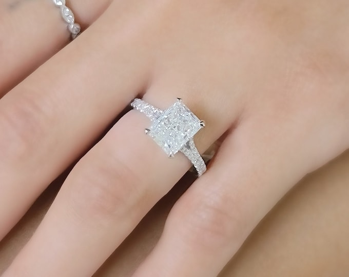 This elegant  14k gold split shank diamond setting features a 3 carat elongated radiant cut IGI certified CVD lab grown diamond