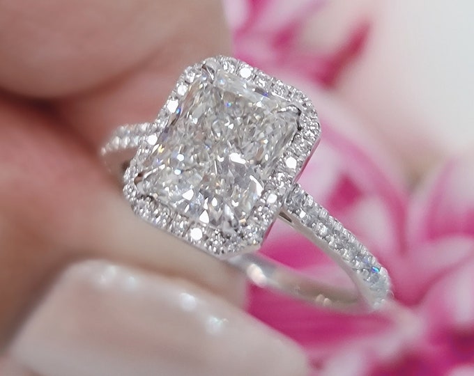 This unique pave diamond & halo setting features a 2.50 Carat elongated radiant Cut IGI Certified CVD lab grown diamond & 0.30 carats accent diamonds