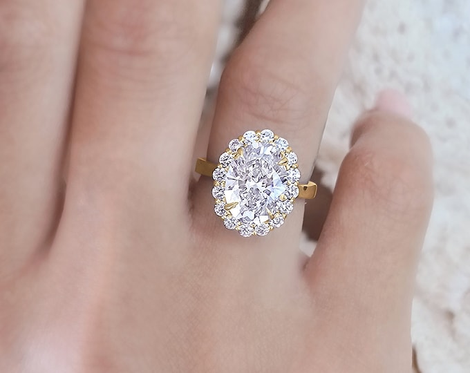 This Victorian style 14K yellow gold cathedral setting features a unique diamond halo with a 3 carat IGI Certified lab grown oval diamond