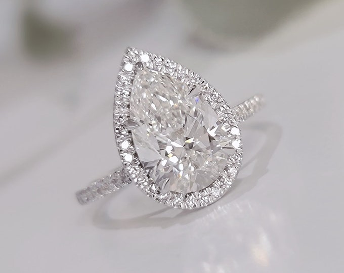 This classic diamond halo pave setting features a 3 carat IGI certified CVD lab grown teardrop diamond & 0.29 carats accent diamonds