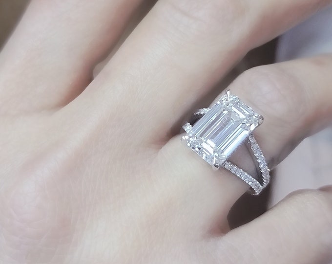 This elegant platinum split shank pave diamond setting features a 6 carat IGI certified CVD lab grown emerald cut diamond & 0.70 carats accent diamonds