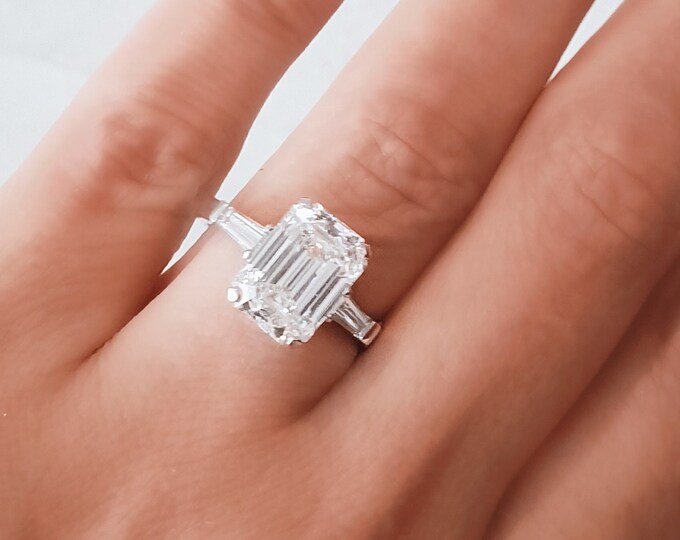 A timeless classic featuring a IGI certified 4 carat emerald cut CVD lab grown diamond complemented by two perfectly matched tapered baguette side diamonds