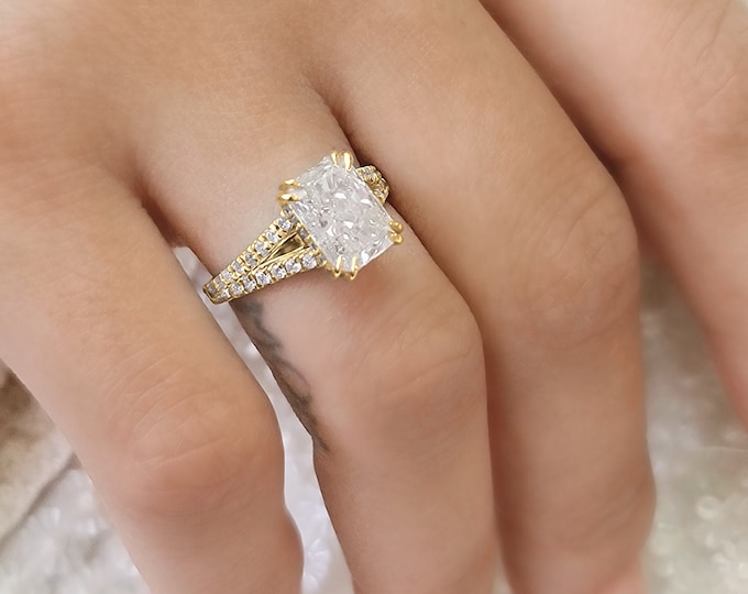 This elegant  14k gold split shank diamond setting features a 2 carat elongated radiant cut IGI certified CVD lab grown diamond