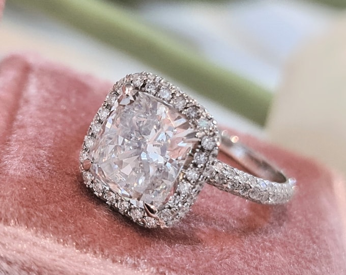 This unique double edge halo 14K gold diamond setting features a 3 carat IGI certified CVD lab grown cushion cut diamond & 0.77 carats accent diamonds