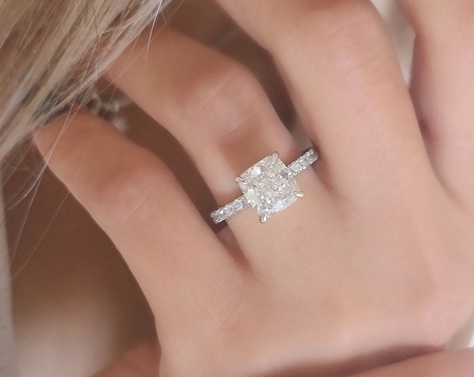 This classic diamond pave setting features a 3 carat IGI certified CVD lab grown cushion cut diamond & 0.34 carats accent diamonds