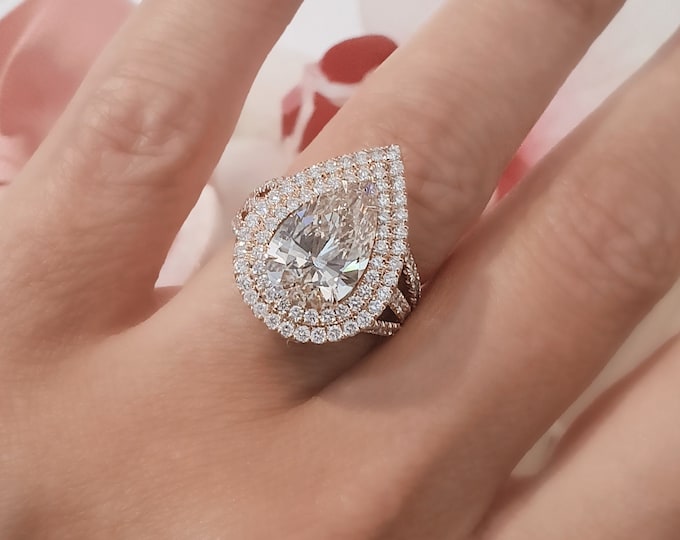 This unique triple split shank Pear shaped diamond Engagement ring set with 1.80 carats accent diamonds features a 3 carat teardrop IGI certified CVD lab grown diamond accentuated with a double halo