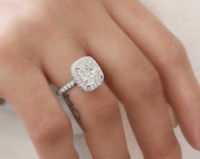 This unique double edge halo 14K gold diamond setting features a 3 carat IGI certified CVD lab grown cushion cut diamond & 1.40 carats accent diamonds
