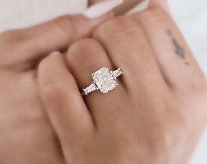 Unique Three Stone Engagement Ring set with a 2.53 carat IGI Certified CVD lab grown Radiant Cut Diamond accentuated with 0.56 carats tapered baguette side diamonds