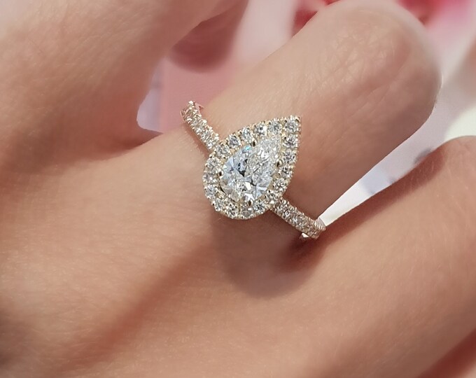 This unique Halo Solitaire diamond 14K yellow gold setting features a 1 carat Pear Cut IGI Certified CVD lab grown diamond and 0.35 carats accent diamonds