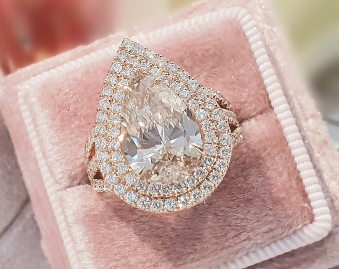 This unique triple split shank Pear shaped diamond Engagement ring set with 1.80 carats accent diamonds features a 3 carat teardrop IGI certified CVD lab grown diamond accentuated with a double halo
