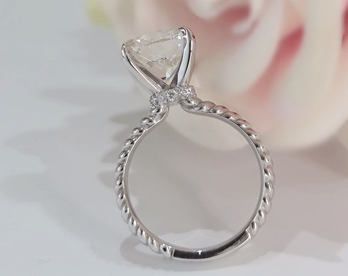 This unique twisted ring design in 14K white gold features a 3 Carat  Round Brilliant cut IGI certified CVD lab grown diamond & a hidden halo set with 0.05ct small diamonds