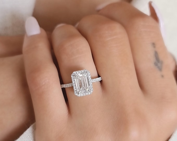 This unique pave diamond & halo setting features a 2 Carat emerald Cut IGI Certified CVD lab grown diamond & 0.30 carats accent diamonds