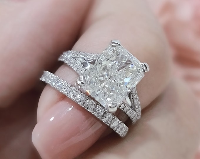 This elegant split shank  hidden halo diamond setting features a 3 carat radiant cut IGI certified CVD lab grown diamond & 0.60 carats accent diamonds