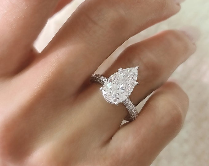This classic diamond halo pave setting features a 4 carat IGI certified CVD lab grown teardrop diamond & 1.23 carats accent diamonds