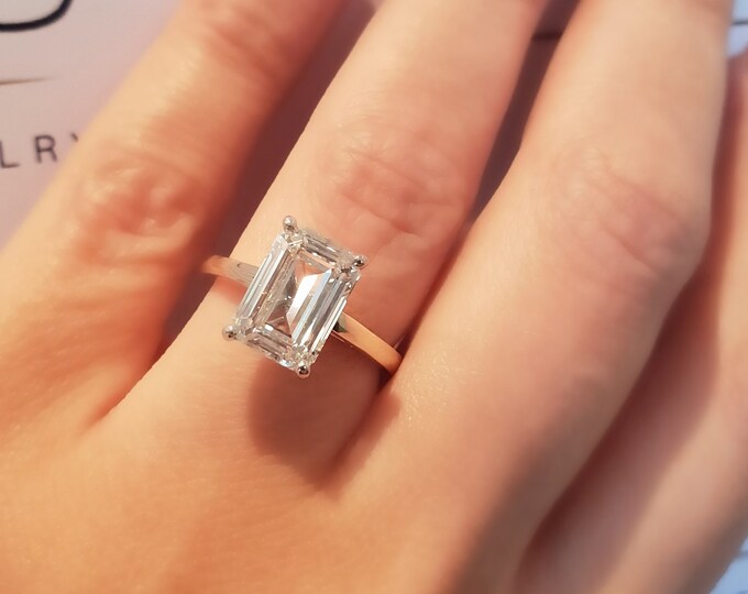 This classic 2 tone 18K gold cathedral setting features a 2.50 carat emerald cut IGI certified CVD lab grown diamond