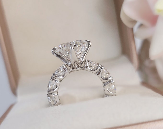 This Victorian style cathedral setting features a unique single prong 0.50 carats diamond halo and is set with a 3 carat center oval cut diamond