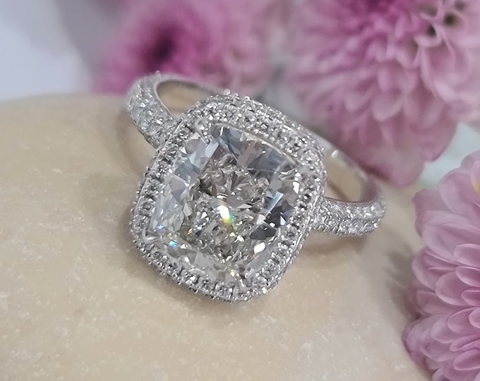 This unique double edge halo 14K gold diamond setting features a 3 carat IGI certified CVD lab grown cushion cut diamond & 0.82 carats accent diamonds