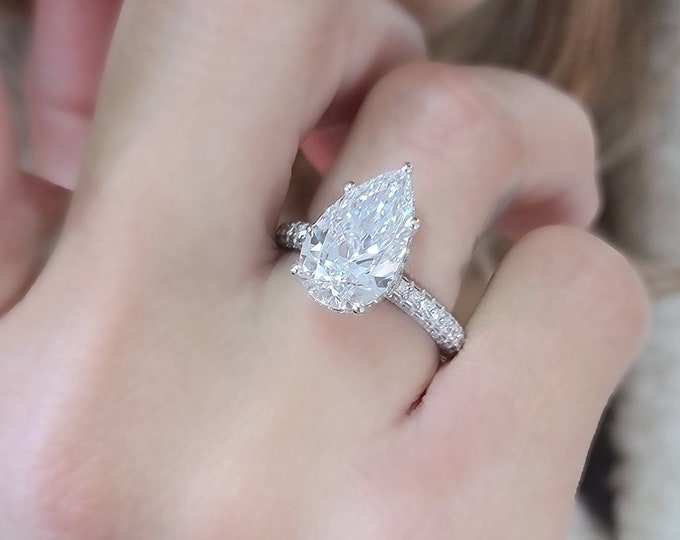 This classic diamond halo pave setting features a 5 carat IGI certified CVD lab grown teardrop diamond & 1.35 carats accent diamonds