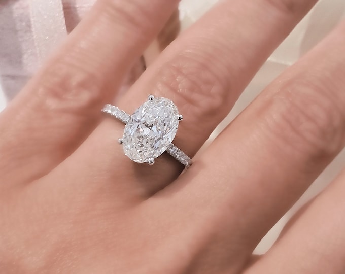 3 Carat Oval Cut IGI Certified CVD Lab Grown Diamond set in a stunning hidden halo and diamond pave band setting