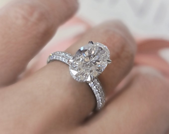 This unique diamond setting features a 2.50 carat Oval cut IGI certified CVD lab grown diamond and 0.71 carats accent diamonds