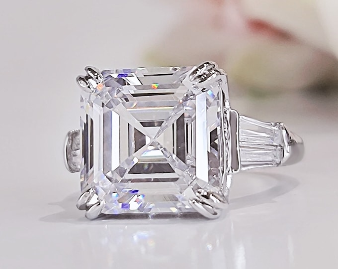 This unique multi stone platinum ring features an 8 Carat Asscher Cut IGI certified CVD lab grown Diamond and 0.80 carats tapered baguette side stones