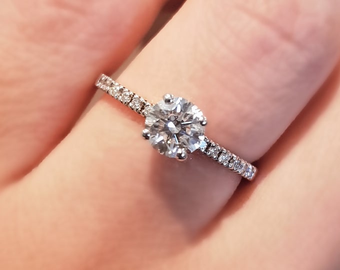 This 14K white gold Classic pave set diamond ring  is set with a 1 carat Round Cut IGI certified CVD lab grown diamond