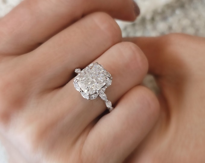 This Victorian style cathedral setting features a unique single prong 0.50 carats diamond halo and is set with a 3 carat center oval cut diamond