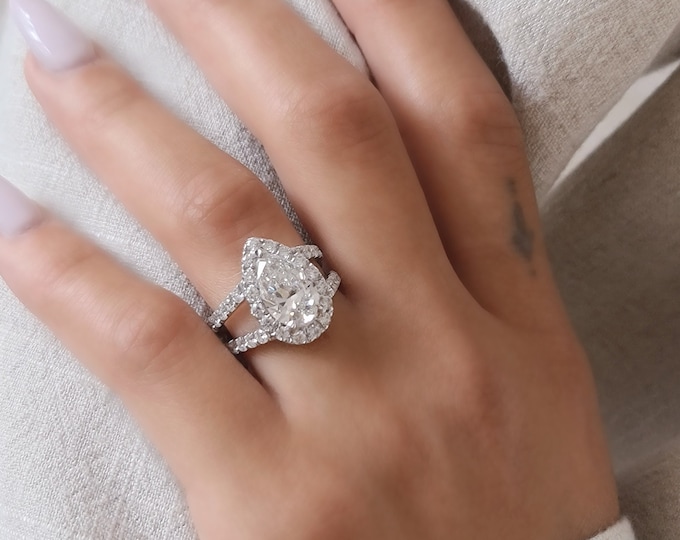 This unique split shank diamond pave setting with a 2.50 carat IGI certified CVD lab grown Pear cut diamond and 1.80 carats accent diamonds