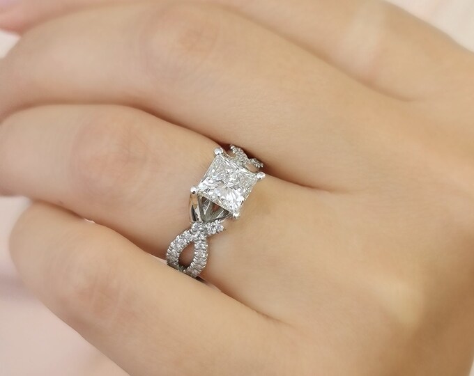 This unique twisted 14K white gold setting features a 2 carat princess cut IGI certified CVD lab grown diamond and 0.30ct princess cut side diamonds