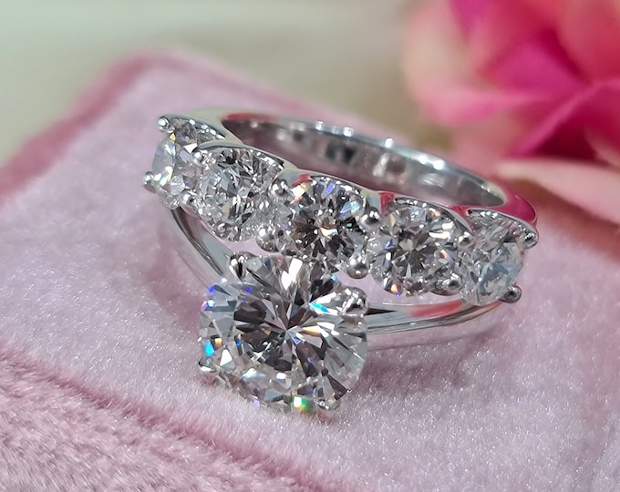 This wedding ring set features a 3 CT Round Cut IGI Certified CVD Lab Grown Diamond in a cathedral setting and 1.25 carat five stone 14K white gold diamond wedding  band